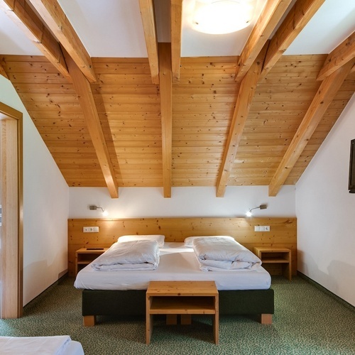 a bedroom with two beds and a flat screen tv