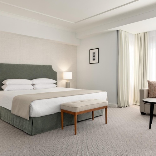 a hotel room with a large bed and a couch