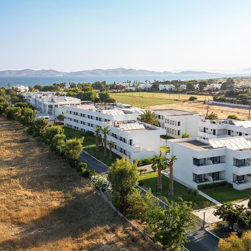 an aerial view of a hotel with mountains in the background