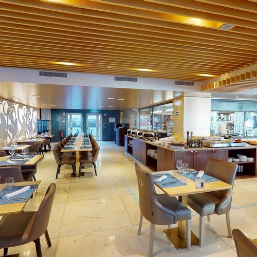 a restaurant with tables and chairs and a buffet