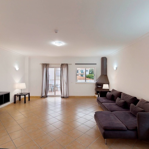 a living room with a flat screen tv and a couch