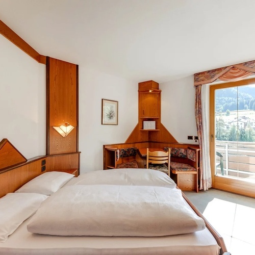 a hotel room with two beds and a chair