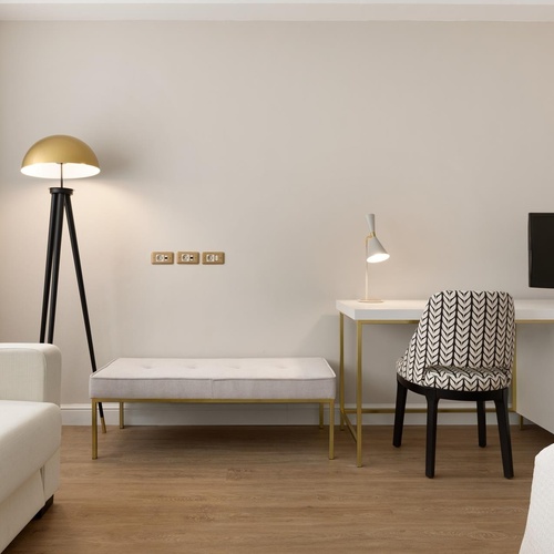 a room with a couch and a desk with a computer on it