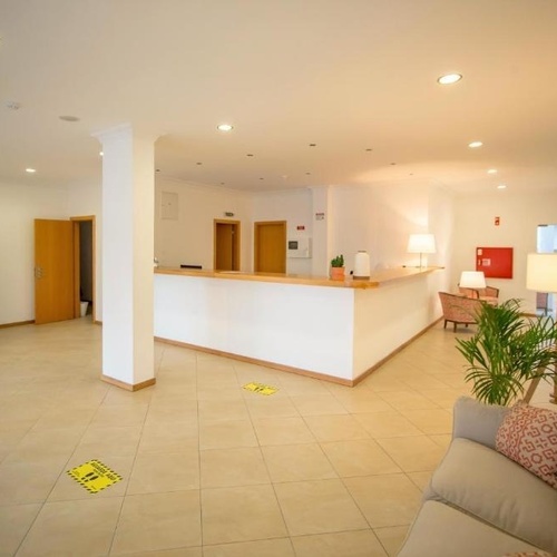 a lobby with a couch and a vending machine