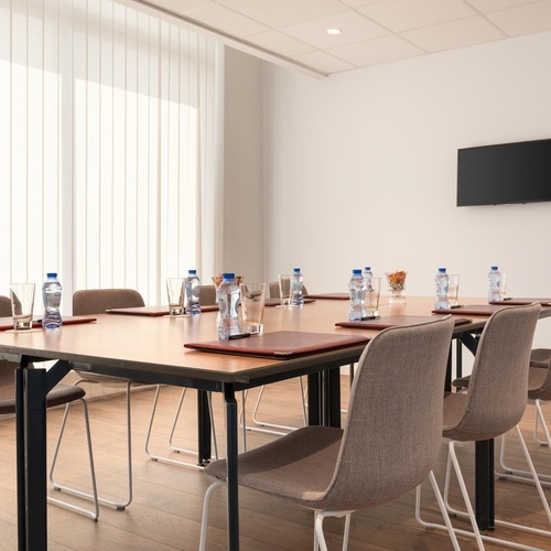 a conference room with a long table and chairs