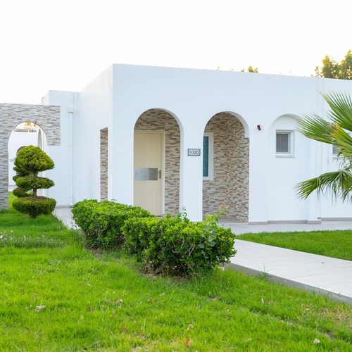 a white house with a sign on the door that says ' a '