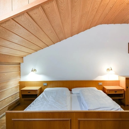 a bedroom with two beds and a picture on the wall