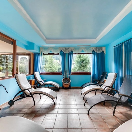 a room with a lot of chairs and blue walls