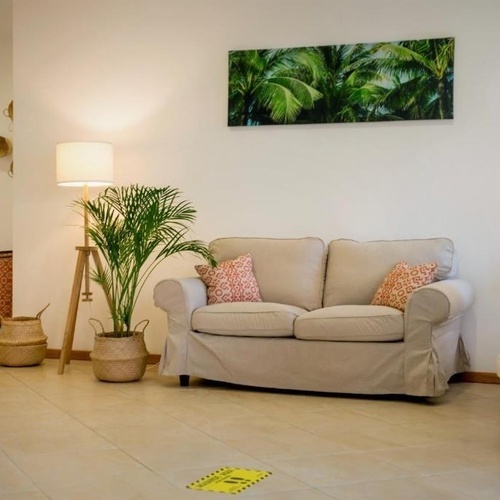 a living room with a couch and a picture on the wall