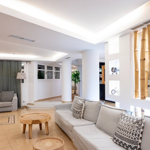 a living room with a couch and two tables