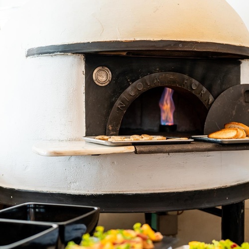 a pizza oven with the word nicola on it
