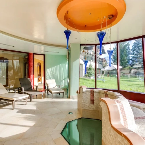 a room with a lot of windows and chairs