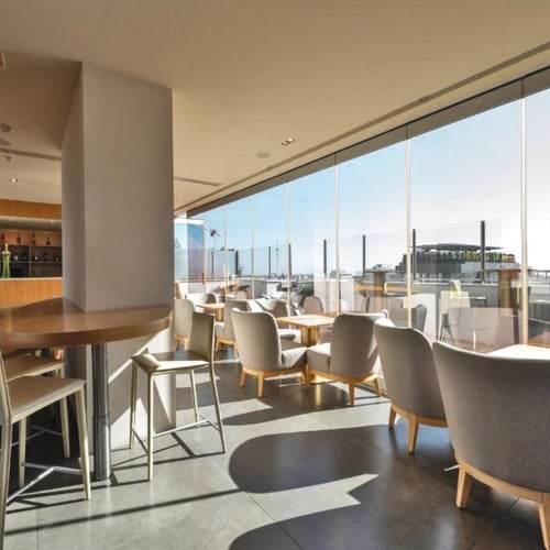 a restaurant with tables and chairs and a large window