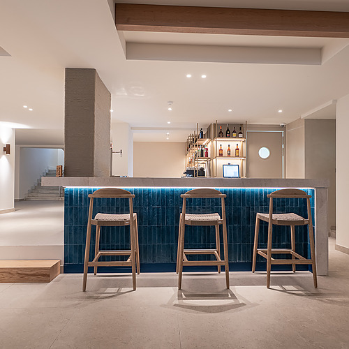 Stylish Smy: Corporativa hotel lobby with central olive tree and circular seating.