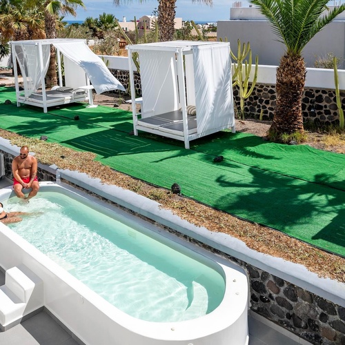 un homme et une femme sont assis dans une piscine blanche