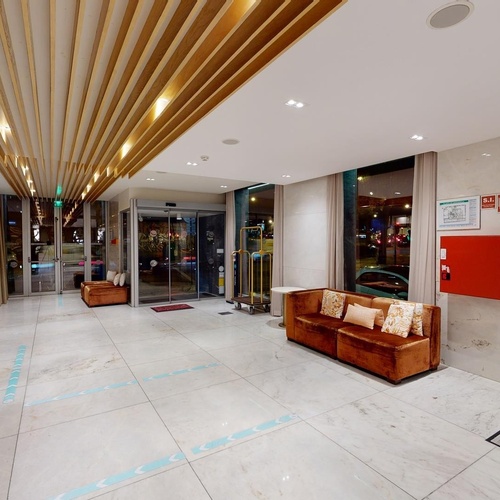 a hotel lobby with a fire extinguisher on the wall