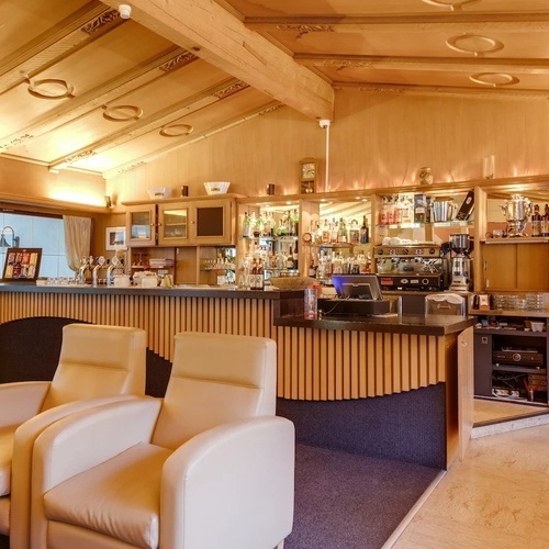 a restaurant with a bar and a few chairs