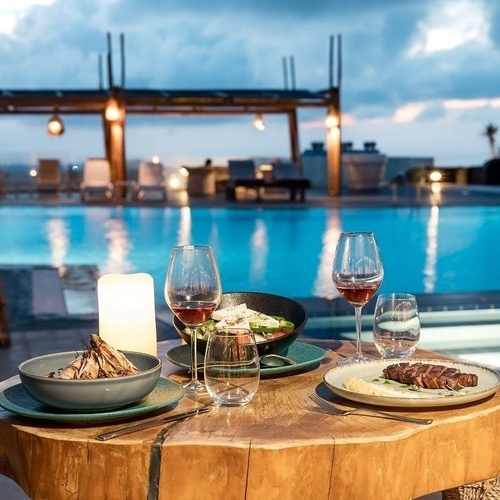 a restaurant with a view of the ocean and the sunset