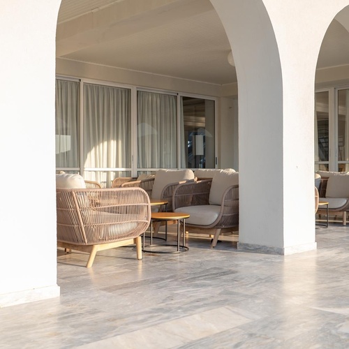 a row of chairs and a couch in a room with arches