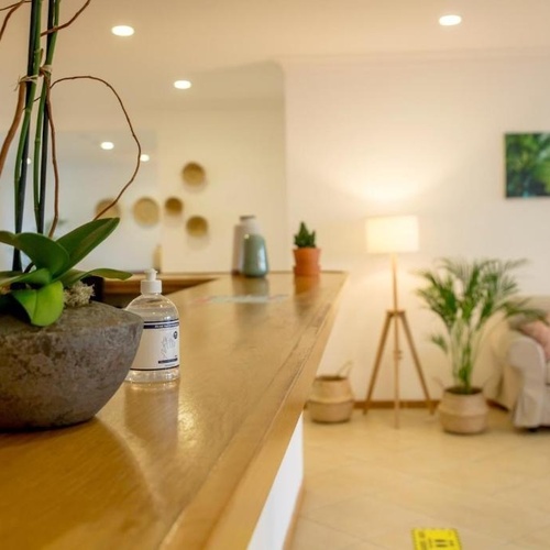 a bottle of hand sanitizer sits on a counter in a living room