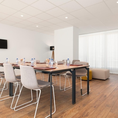 a conference room with a long table and chairs