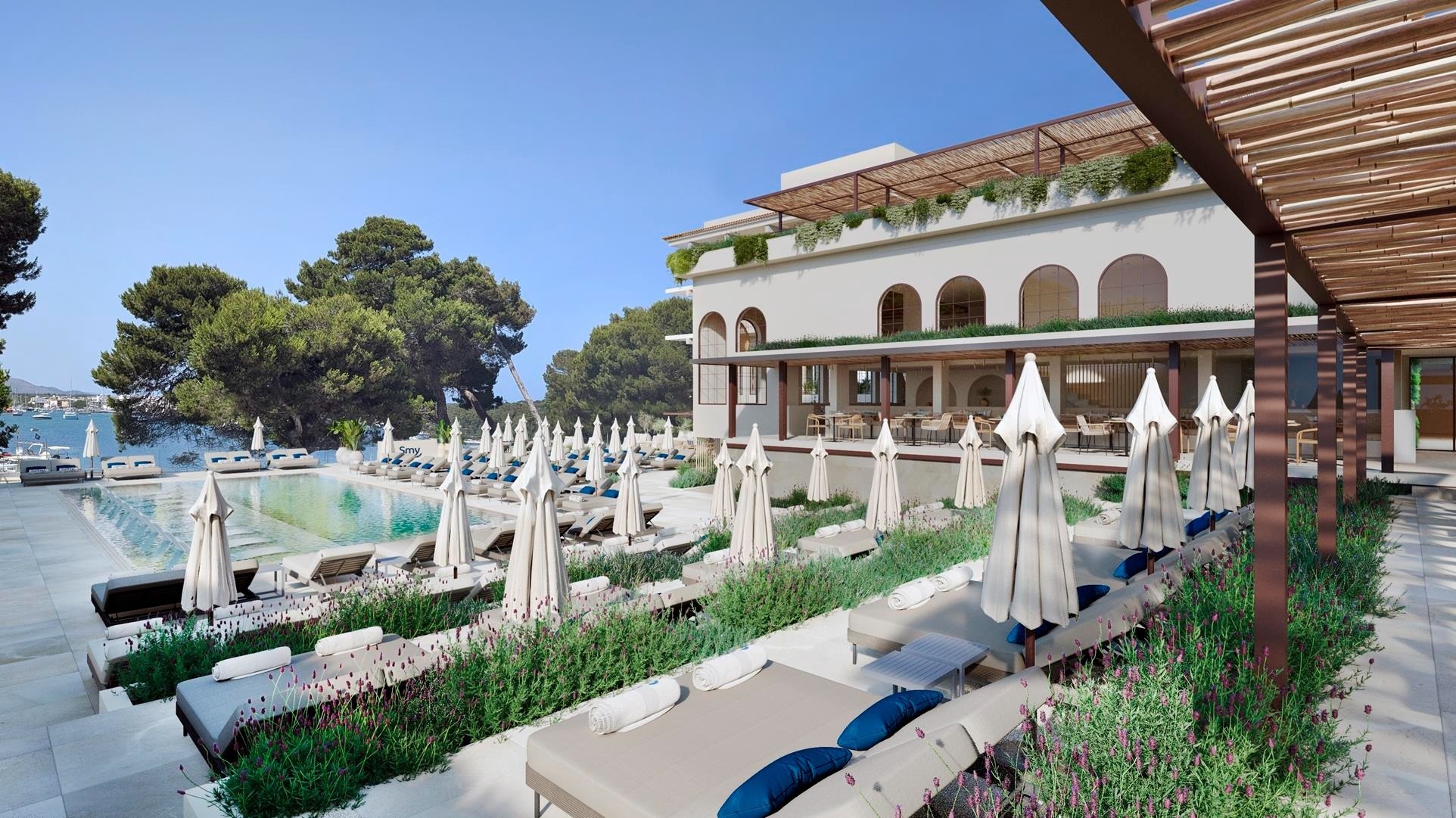 a glass of red liquid with a straw on the beach