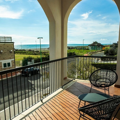 ein Balkon mit Blick auf die Straße und das Meer