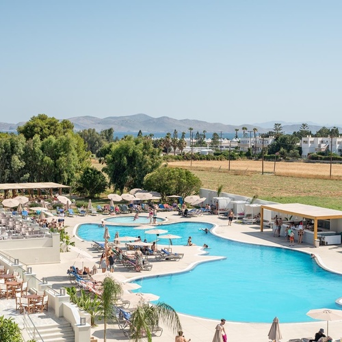 a large swimming pool is surrounded by chairs and umbrellas