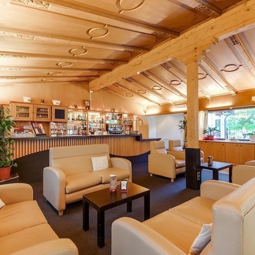 a large swimming pool surrounded by chairs and umbrellas