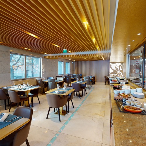 a restaurant with tables and chairs and a buffet