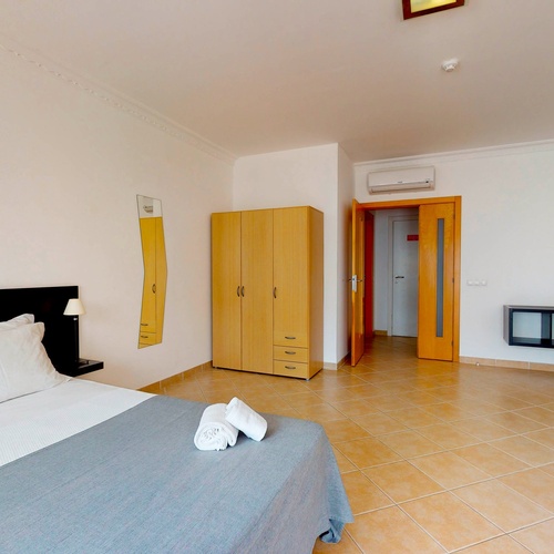 a bedroom with a bed and a tv that says city hotels