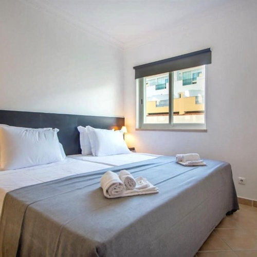 a hotel room with two beds and a window