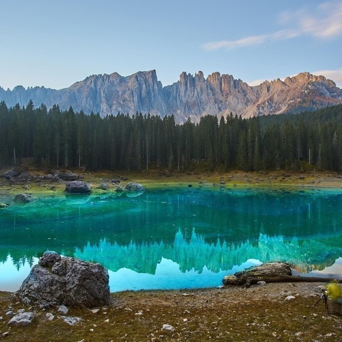 a hotel room with a large bed and a painting on the wall