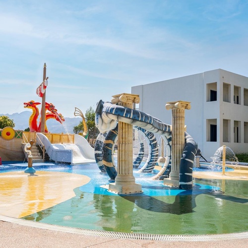 a water park with a slide and a pirate ship
