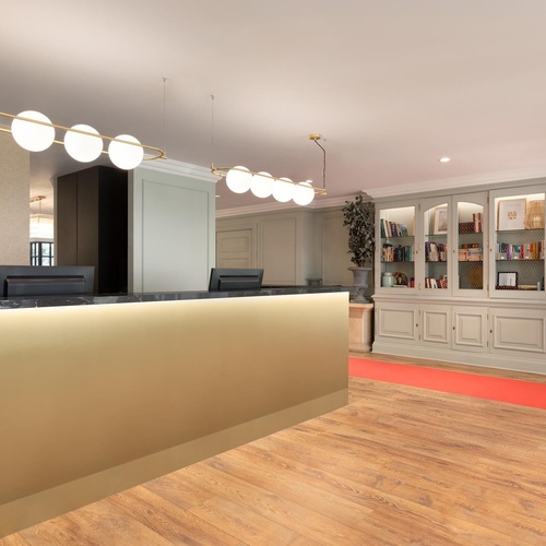 a gold reception desk with a computer on it