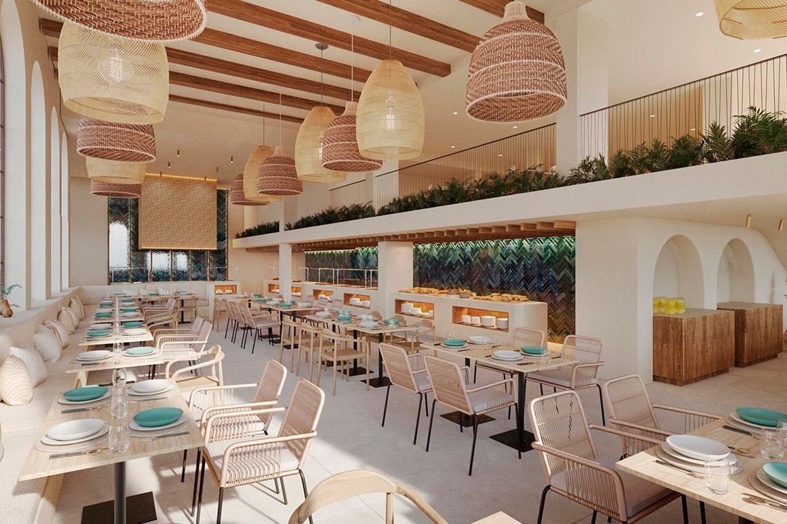 a glass of red liquid with a straw on the beach