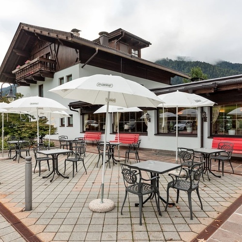 a patio with tables and chairs and umbrellas that say ' caffe ' on them