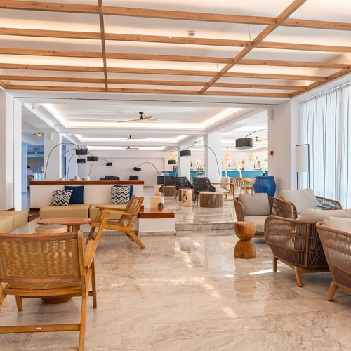 a large room with a lot of furniture and a wooden ceiling