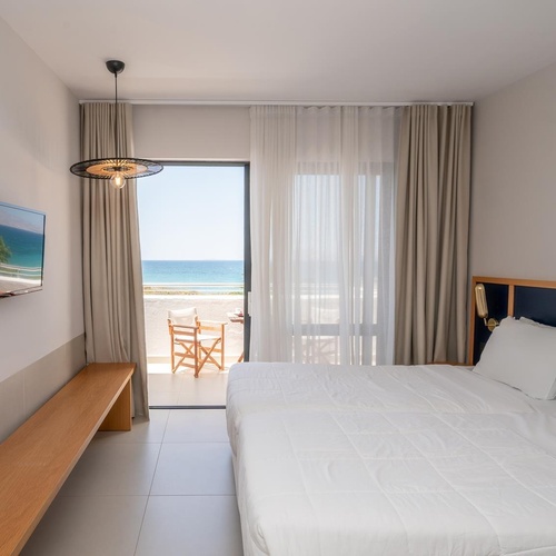 a hotel room with a large bed and a flat screen tv