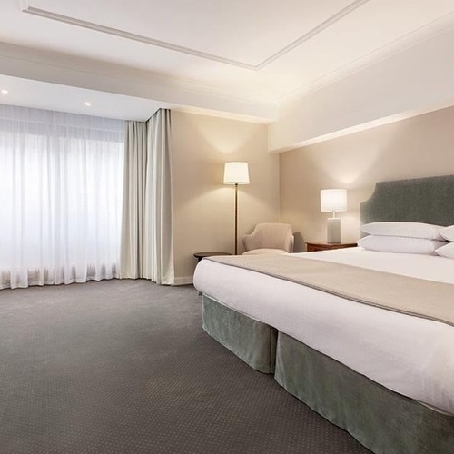 a hotel room with a large bed and a desk