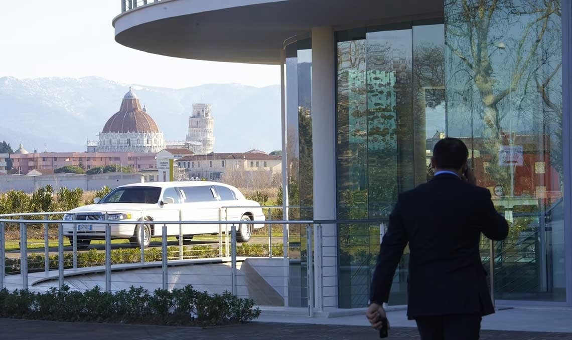 a glass of red liquid with a straw on the beach