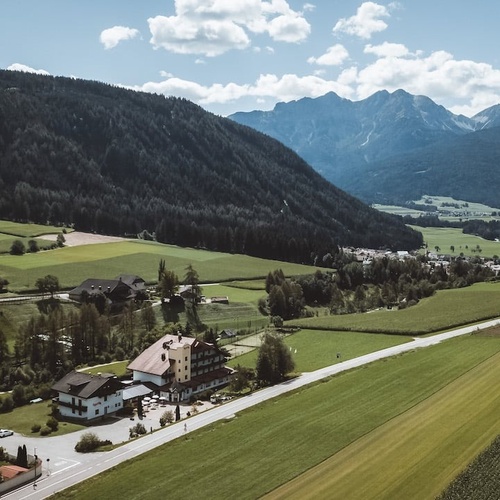 an aerial view of a valley with mountains in the background