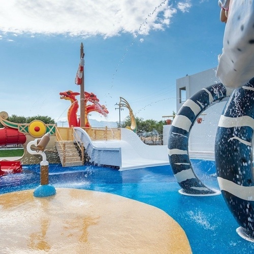 a large swimming pool surrounded by chairs and umbrellas