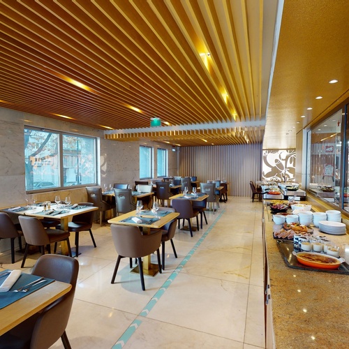 a restaurant with tables and chairs and a buffet