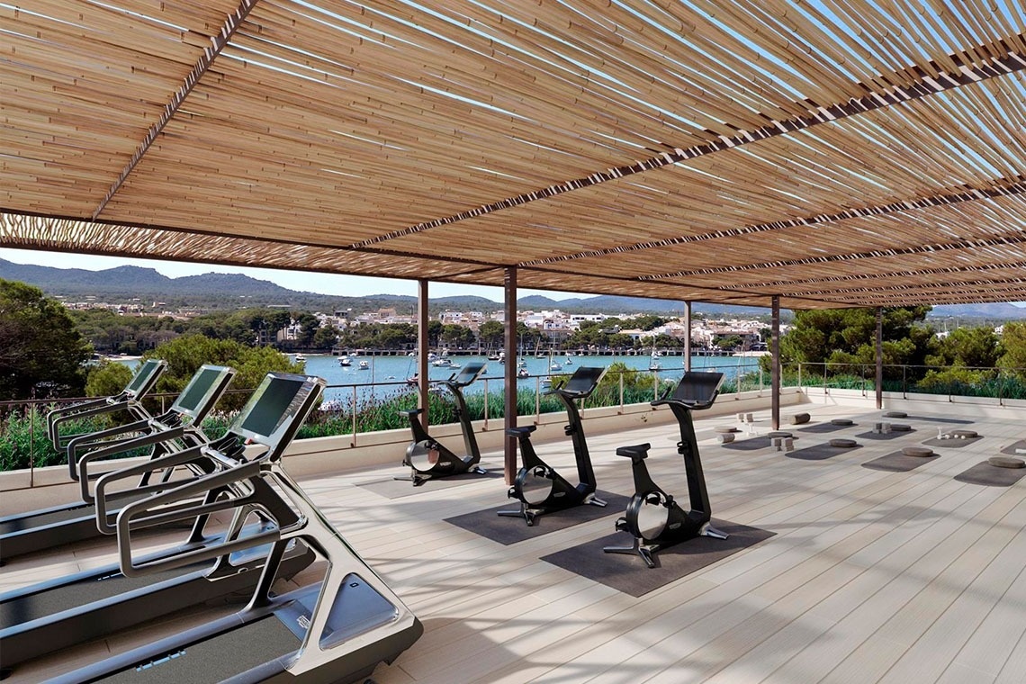 a glass of red liquid with a straw on the beach