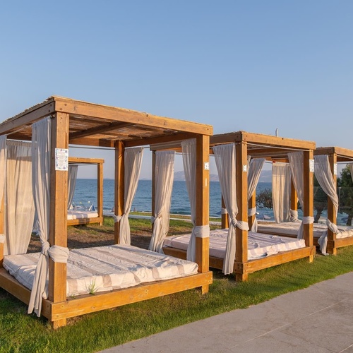 a row of canopies with white curtains and a sign that says ' a ' on it