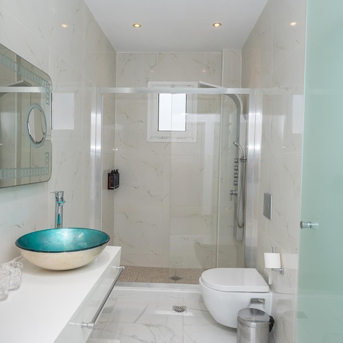 a bathroom with a blue sink and a toilet