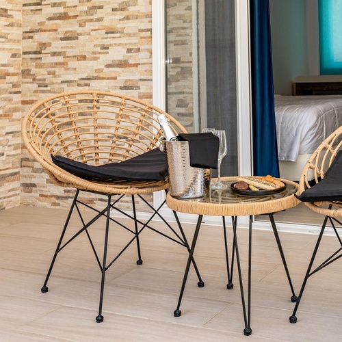 two chairs and a table with a bottle of champagne on it