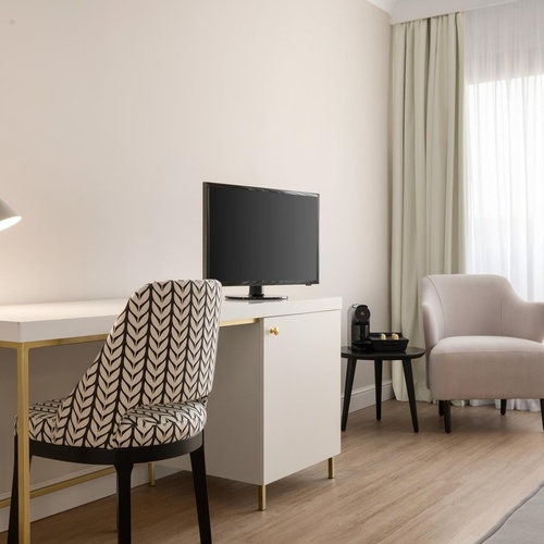 a desk with a tv on it and a chair