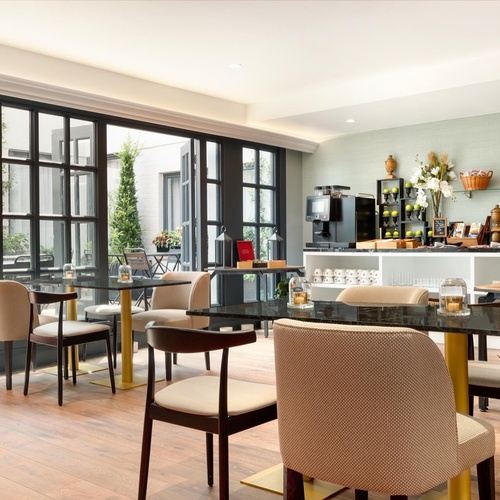a dining room with tables and chairs and a large window